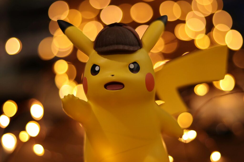 pexels-photo-1716861-1716861 A close-up of a Pikachu figurine illuminated by a warm bokeh effect, creating an eye-catching visual.